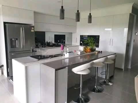 Island kitchen with seating and full-height storage